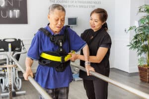A physical therapist and a resident at the Canyon Springs rehab gym